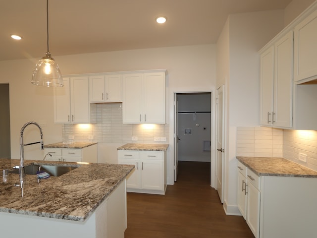 740 Autumn Cherry Trl, Magnolia, TX 77354 - kitchen with a sink, light stone counters, backsplash, dark wood-style floors, and recessed lighting