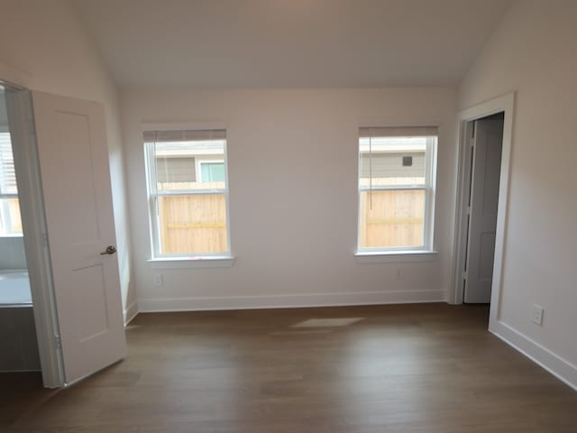 740 Autumn Cherry Trl, Magnolia, TX 77354 - unfurnished bedroom featuring lofted ceiling, dark wood finished floors, and baseboards