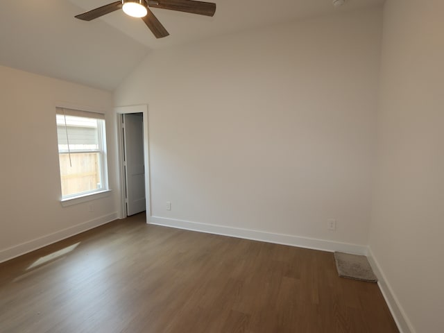 740 Autumn Cherry Trl, Magnolia, TX 77354 - empty room with baseboards, dark wood-style floors, ceiling fan, and vaulted ceiling