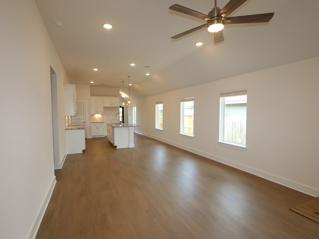 740 Autumn Cherry Trl, Magnolia, TX 77354 - unfurnished living room with baseboards, recessed lighting, dark wood-style flooring, ceiling fan, and vaulted ceiling