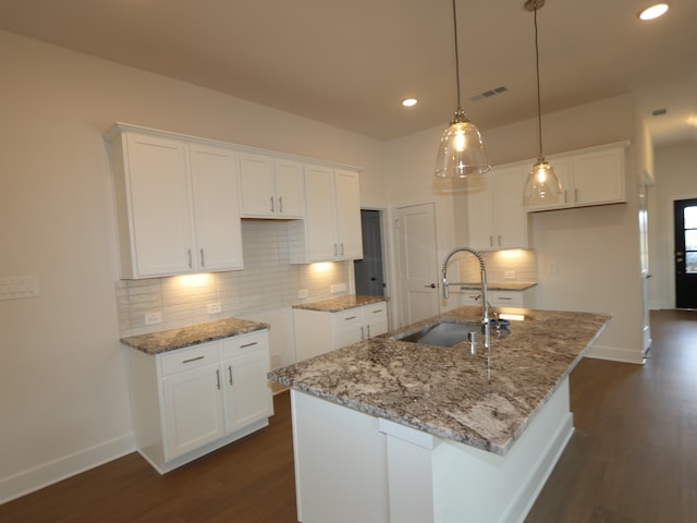 740 Autumn Cherry Trl, Magnolia, TX 77354 - kitchen with a sink, an island with sink, light stone countertops, white cabinets, and recessed lighting