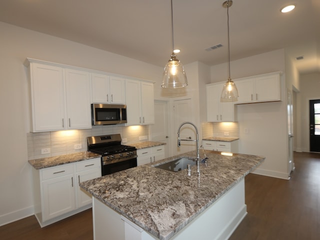 740 Autumn Cherry Trl, Magnolia, TX 77354 - kitchen with appliances with stainless steel finishes, white cabinets, tasteful backsplash, and recessed lighting