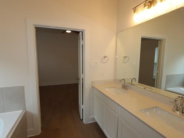 740 Autumn Cherry Trl, Magnolia, TX 77354 - full bath featuring wood finished floors, double vanity, and a bathtub