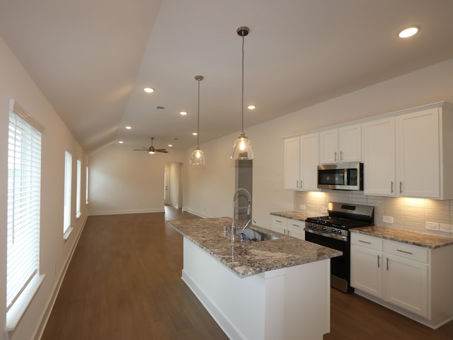 740 Autumn Cherry Trl, Magnolia, TX 77354 - kitchen with appliances with stainless steel finishes, decorative backsplash, dark wood finished floors, lofted ceiling, and white cabinetry