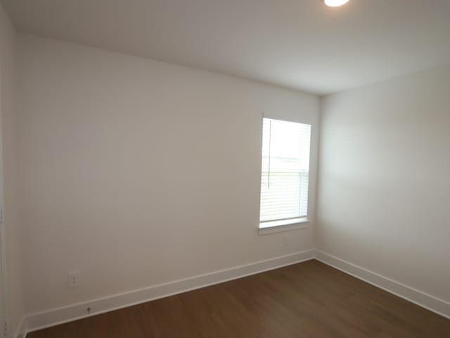 740 Autumn Cherry Trl, Magnolia, TX 77354 - empty room featuring dark wood finished floors and baseboards