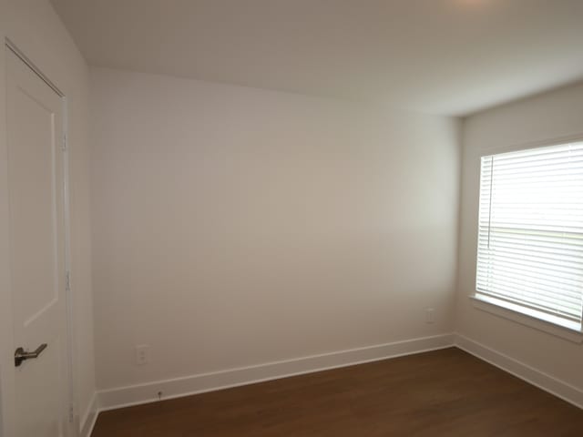 740 Autumn Cherry Trl, Magnolia, TX 77354 - spare room featuring dark wood finished floors and baseboards