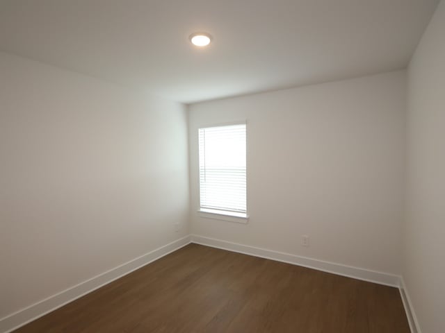 740 Autumn Cherry Trl, Magnolia, TX 77354 - spare room featuring baseboards and dark wood finished floors