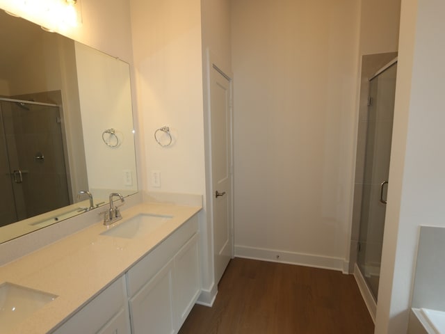 740 Autumn Cherry Trl, Magnolia, TX 77354 - full bathroom featuring wood finished floors, double vanity, and a shower stall
