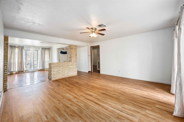 unfurnished living room with ceiling fan and light hardwood / wood-style floors