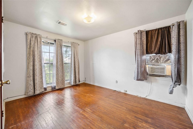 spare room featuring hardwood / wood-style floors and cooling unit