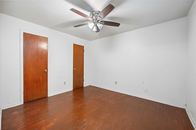 unfurnished room featuring ceiling fan and dark hardwood / wood-style flooring