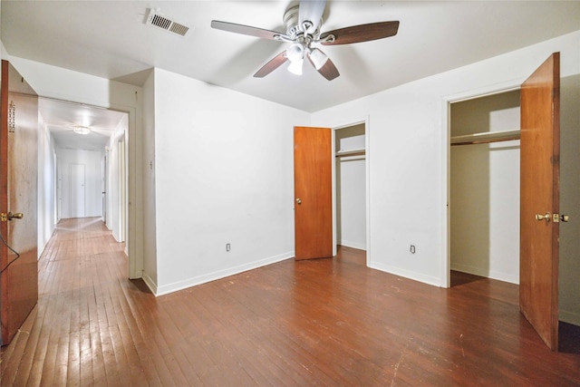 unfurnished bedroom featuring ceiling fan and dark hardwood / wood-style floors