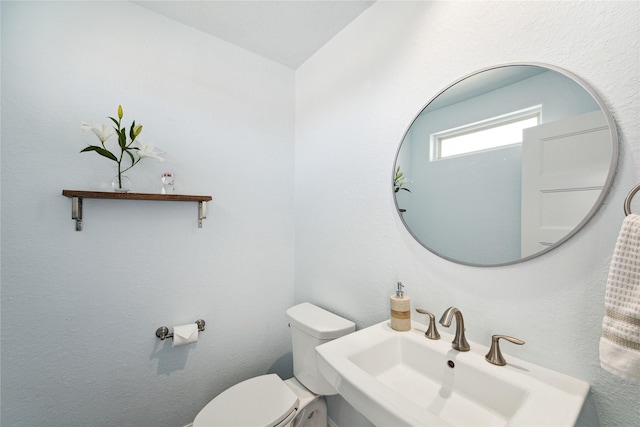 bathroom featuring sink and toilet