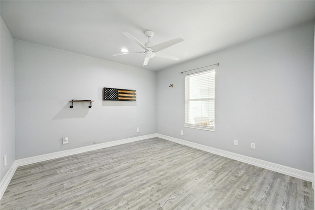 spare room with light hardwood / wood-style floors and ceiling fan