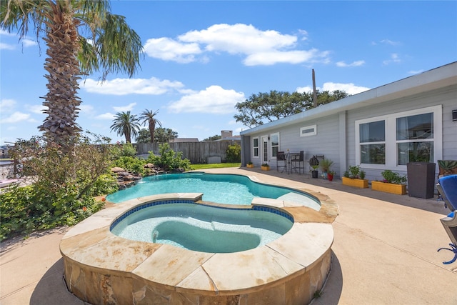 view of pool with an in ground hot tub and a patio