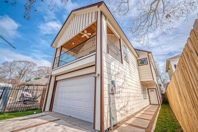 view of property exterior featuring a garage and a balcony