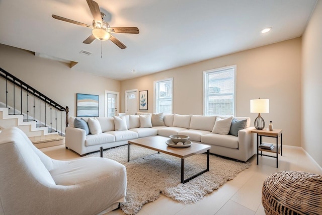 living room with light hardwood / wood-style flooring and ceiling fan