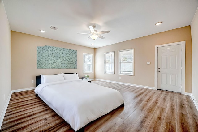 bedroom with hardwood / wood-style flooring and ceiling fan