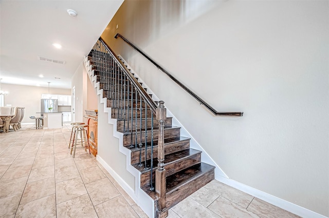 stairway with tile patterned floors