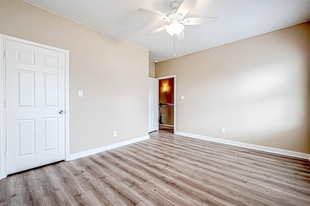 spare room featuring ceiling fan and light wood-type flooring