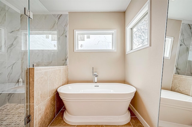 bathroom featuring shower with separate bathtub