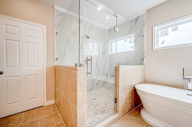 bathroom with independent shower and bath and tile patterned floors