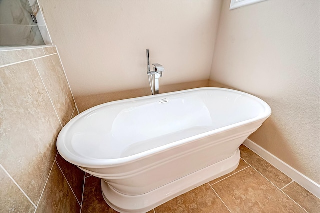 bathroom with tile patterned flooring and a bathing tub