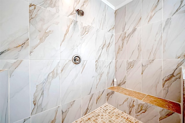 bathroom featuring ornamental molding and a tile shower