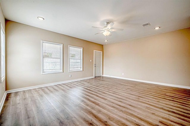 spare room with ceiling fan and light hardwood / wood-style floors