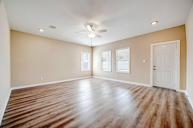 spare room with light hardwood / wood-style flooring and ceiling fan