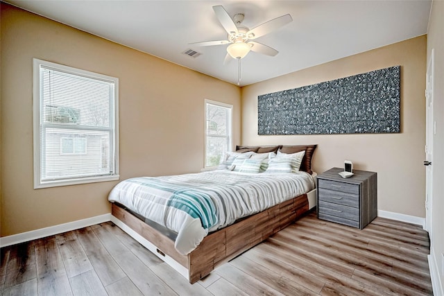 bedroom with ceiling fan and light hardwood / wood-style floors