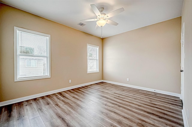 unfurnished room with ceiling fan and light wood-type flooring