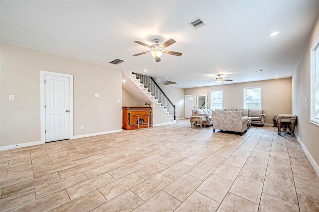 unfurnished living room with ceiling fan and light tile patterned flooring