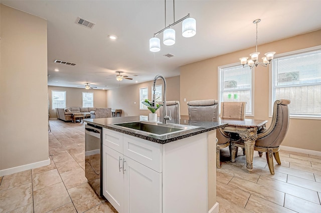 kitchen with white cabinetry, pendant lighting, dishwasher, and a center island with sink