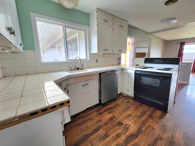 kitchen featuring electric range oven, tile countertops, sink, dishwasher, and white cabinets