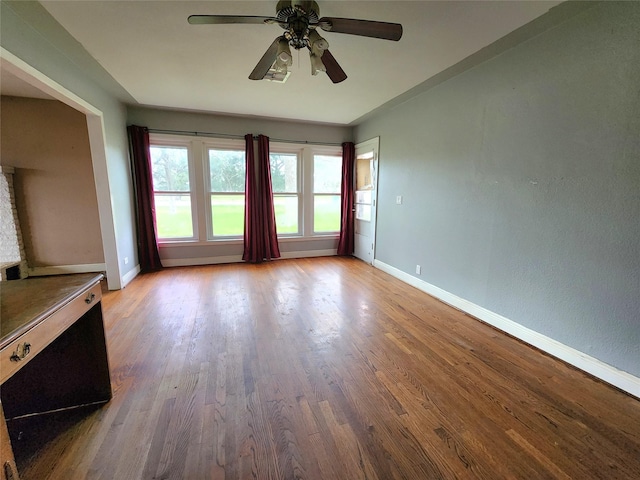 unfurnished living room with light wood-type flooring and ceiling fan