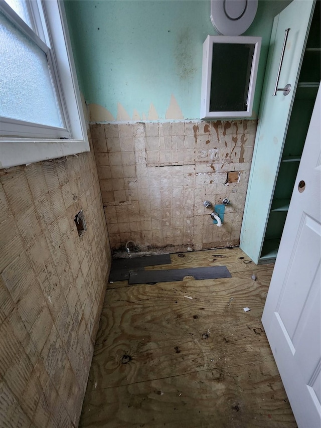 bathroom with tile walls