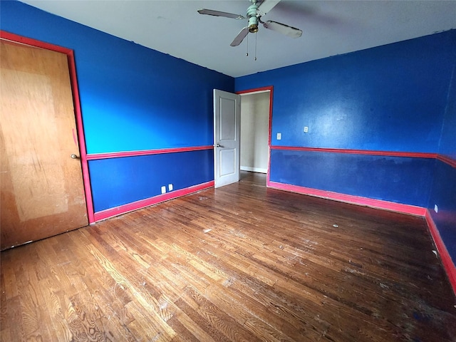 empty room featuring hardwood / wood-style floors and ceiling fan