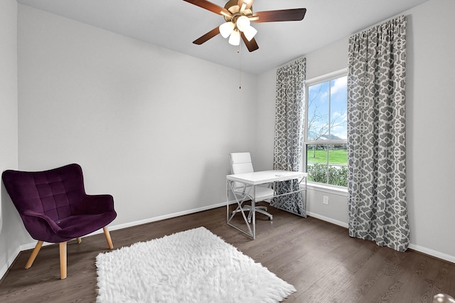 sitting room featuring dark wood-type flooring and ceiling fan