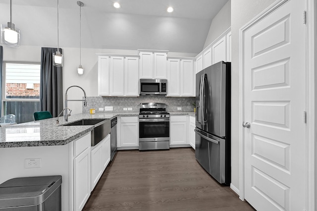 kitchen with sink, white cabinetry, hanging light fixtures, kitchen peninsula, and stainless steel appliances