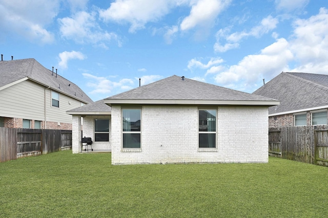 rear view of property with a yard