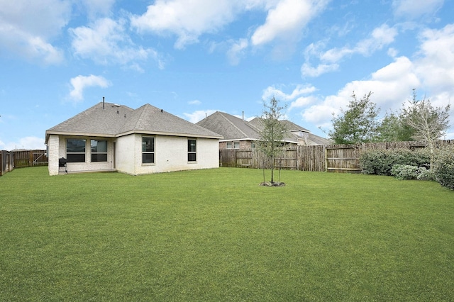 back of house with a lawn