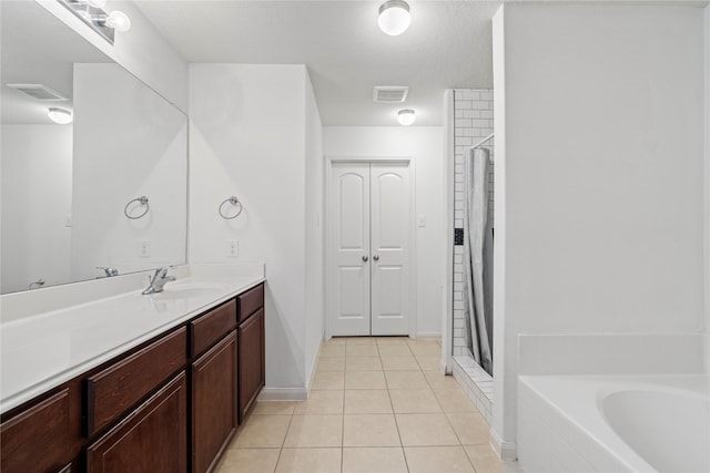 bathroom with vanity, plus walk in shower, and tile patterned flooring