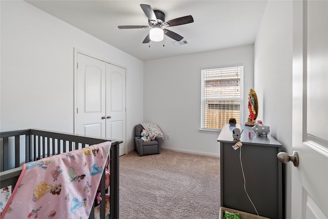 carpeted bedroom featuring a closet and ceiling fan