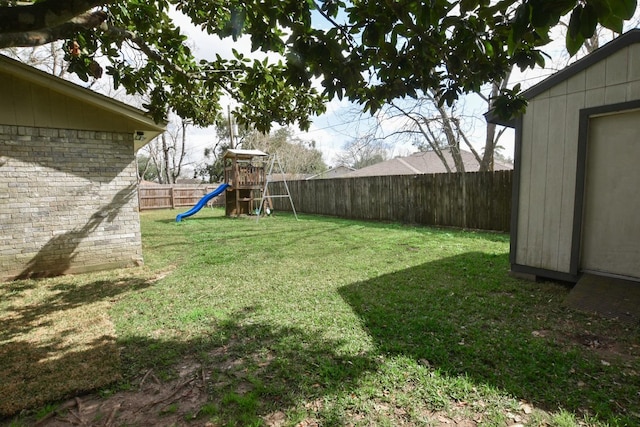 view of yard featuring a playground and a fenced backyard