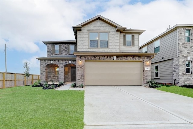 view of front of property featuring a garage and a front yard