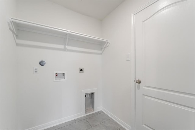 washroom featuring hookup for a washing machine, electric dryer hookup, and light tile patterned floors