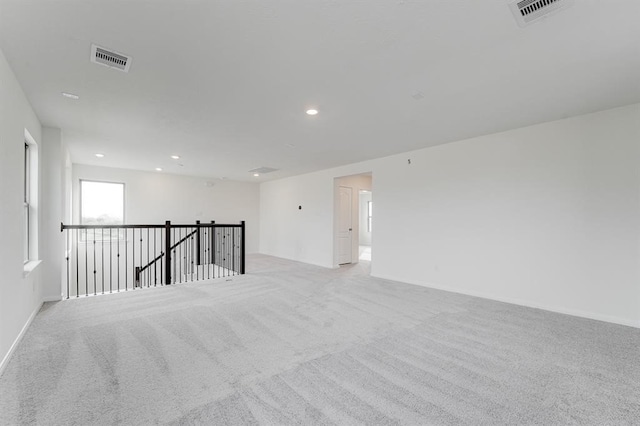 unfurnished room with light colored carpet