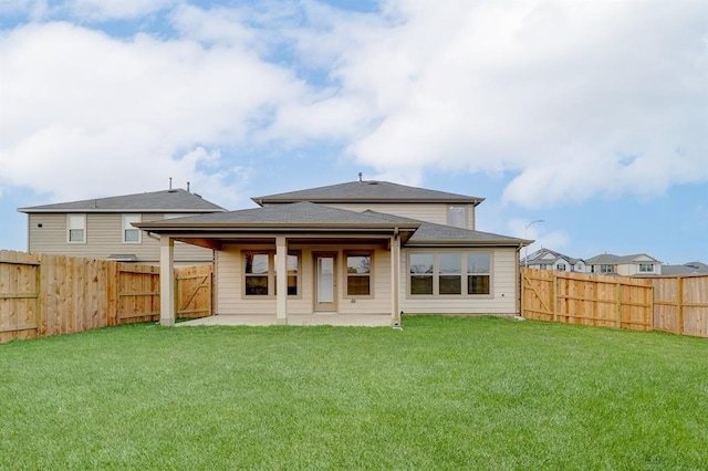 back of property featuring a patio area and a lawn