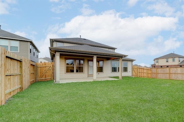 rear view of house with a yard and a patio area